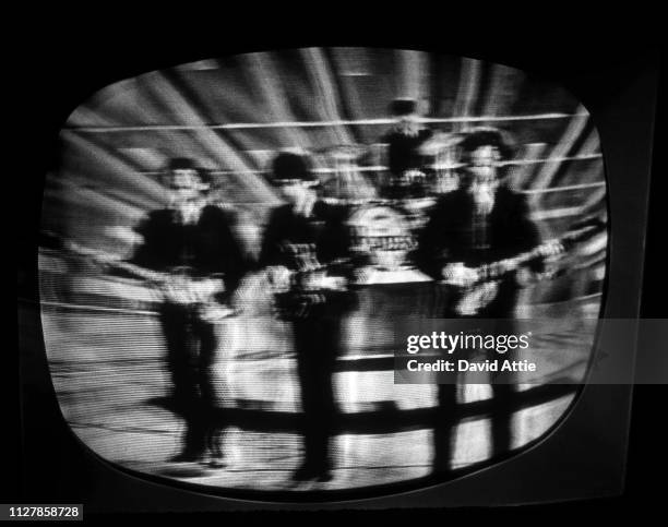 The Beatles perform on the Ed Sullivan Show, shot on a TV screen during the original broadcast on February 9 in New York City, New York.