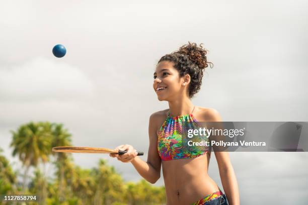 girl playing beach tennis - racket girls stock pictures, royalty-free photos & images