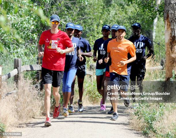 Alan Culpepper, left, leads a training run with Bertine Laine', Astrel Clovis, Petrus Cesarion, Carline Damour, Jean Macksony, and coach, Gerard...