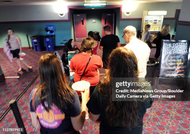 Jerry Ryan, right, takes his daughters, Grace, Joanie, and their friend, Kelsey Hatley, to one of the final showings at the mall. Scores of people...