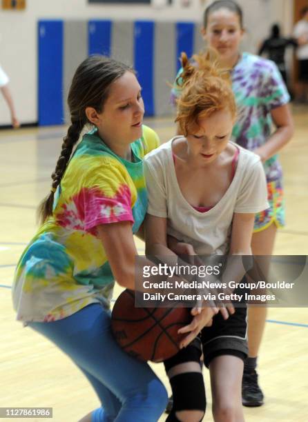 Elizabeth Chudleigh, left, and Alexa Fidler, battle for the ball. The 20th annual Roundball Rukus, at Broomfield Heights Middle School, lets students...