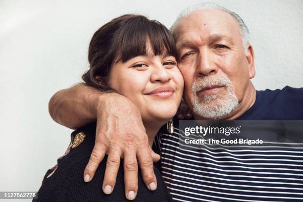 Man embracing teenage granddaughter