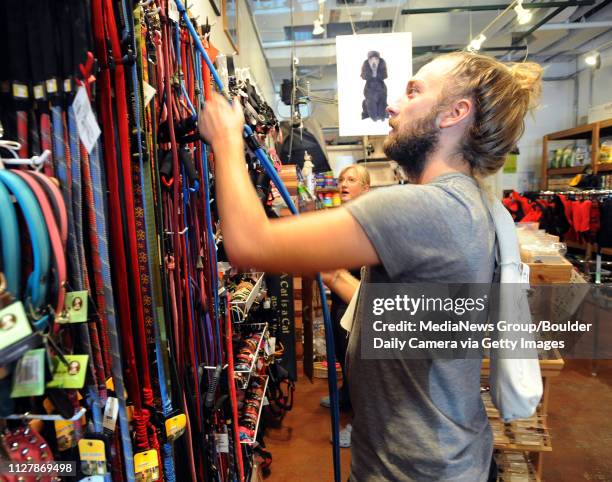 Benjamin Kutsko and his sister, Meghan, shop for dog supplies at Farfel's Farm pet store in Boulder.