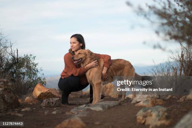 young woman walking her golden retriever - big hug stock pictures, royalty-free photos & images