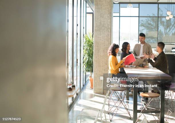 young professionals having a meeting in a modern office space - group of people cafe stock pictures, royalty-free photos & images