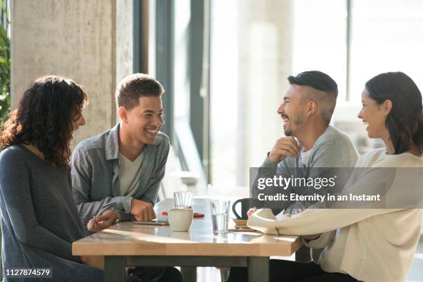 young people having coffee in a cafe - asian friends coffee stock-fotos und bilder