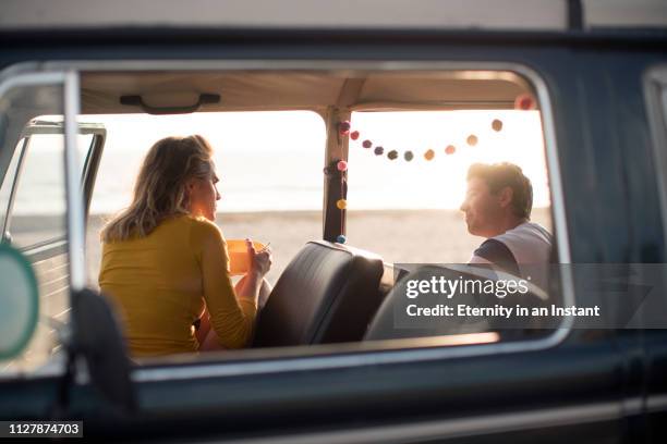 ws young couple on a road trip in a vintage camper van - married car stock pictures, royalty-free photos & images