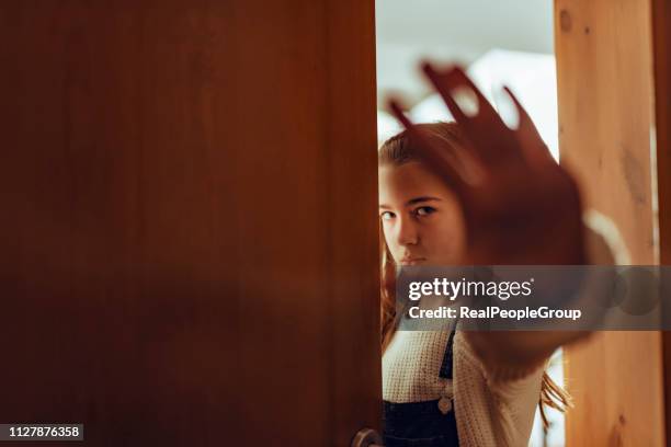sad little girl shows hand stop sign. concept stop child - autodefesa imagens e fotografias de stock