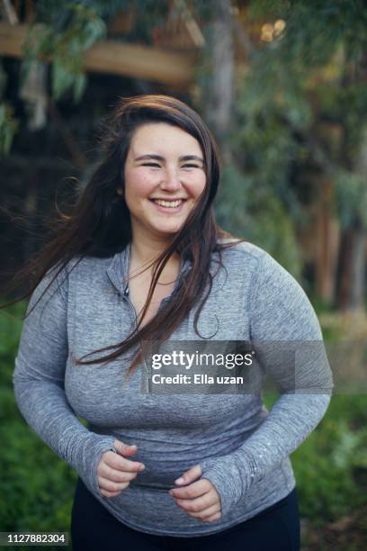 overweight woman running happy in the park - beautiful voluptuous women stock pictures, royalty-free photos & images