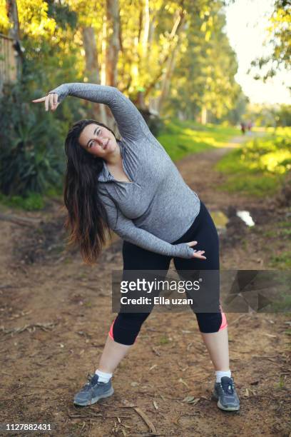 plus size woman exercising in the park