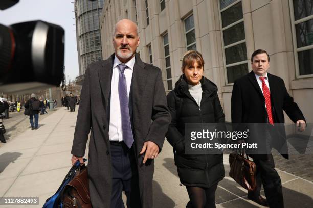 Actress Allison Mack leaves the Brooklyn Federal Courthouse with her lawyers after a court appearance surrounding the alleged sex cult NXIVM on...