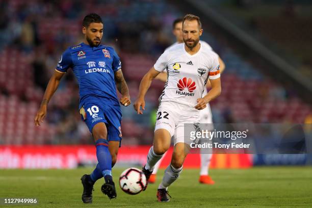 Ronald Vargas of Newcastle Jets contests the ball with Andrew Durante of Wellington Phoenix during the round 18 A-League match between the Newcastle...