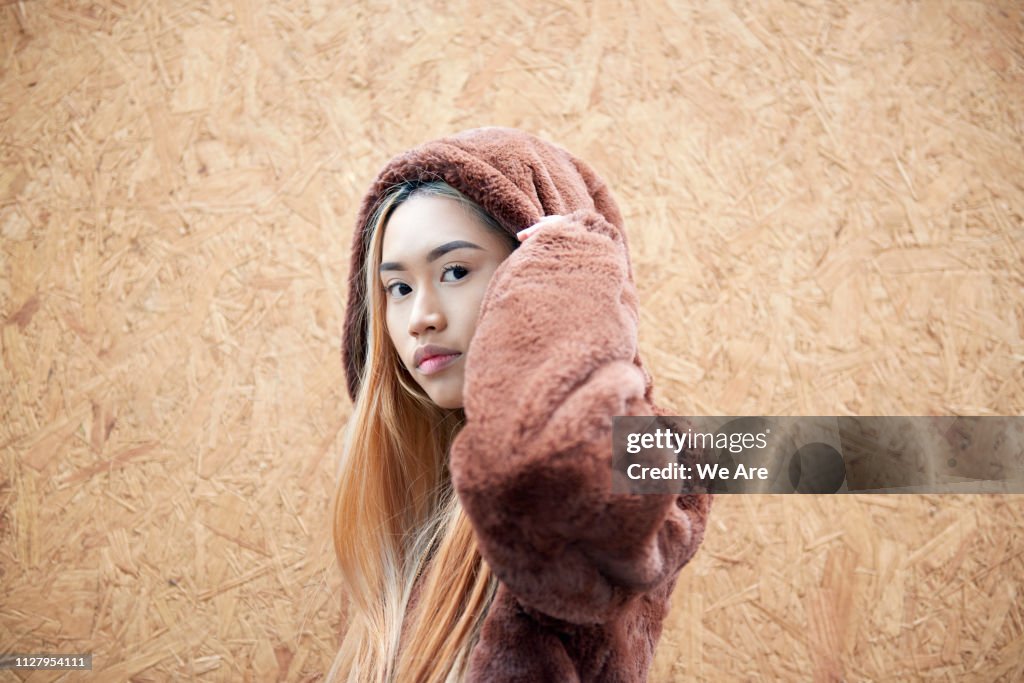 Young woman in hooded fur jacket.