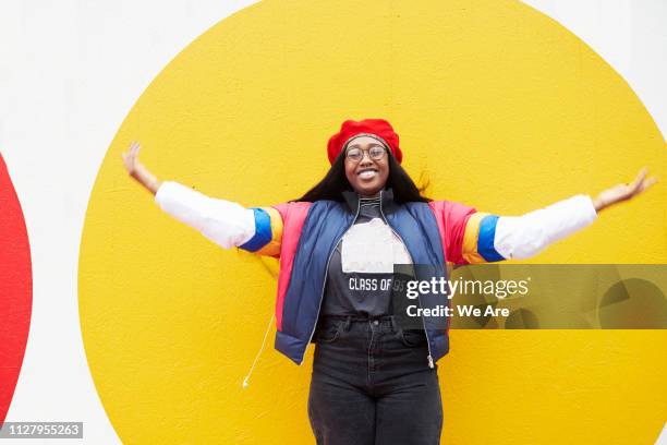 young woman standing with arms outstretched. - things that are round stock-fotos und bilder