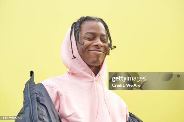 young man smiling with eyes closed. - colour block - fotografias e filmes do acervo