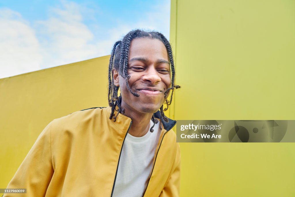 Young fashionable man laughing.