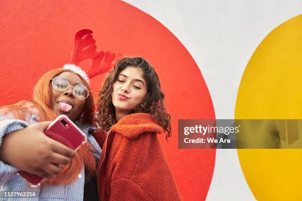 friends taking a festive selfie - generation z selfie stock pictures, royalty-free photos & images