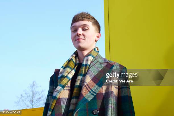 fashionable young man in tartan coat. - modern manlighet bildbanksfoton och bilder