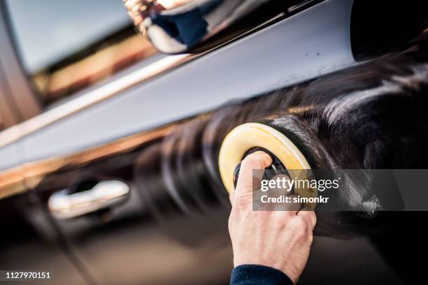 mature man polishing car with applicator pad - polir imagens e fotografias de stock