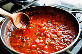 Preparing fresh tomato sauce in a domestic kitchen.