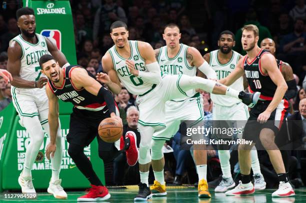 Enes Kanter of the Portland Trail Blazers fights for the rebound against Jayson Tatum and Jaylen Brown of the Boston Celtics at TD Garden on February...