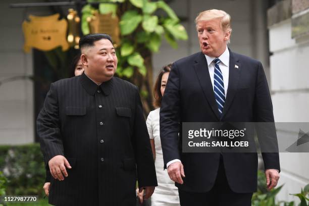 President Donald Trump walks with North Korea's leader Kim Jong Un during a break in talks at the second US-North Korea summit at the Sofitel Legend...