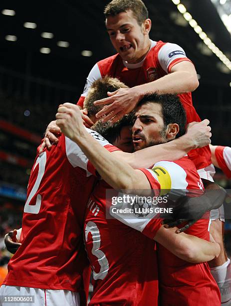 Arsenal's players celebrate after a goal during the Champions League round of 16 first leg football match Arsenal vs FC Barcelona on February 16,...