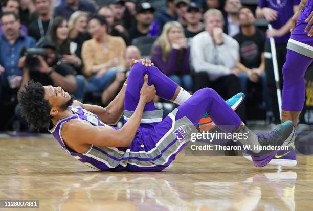 Marvin Bagley III of the Sacramento Kings falls to the floor holding his left knee after getting hurt against the Milwaukee Bucks during the second...