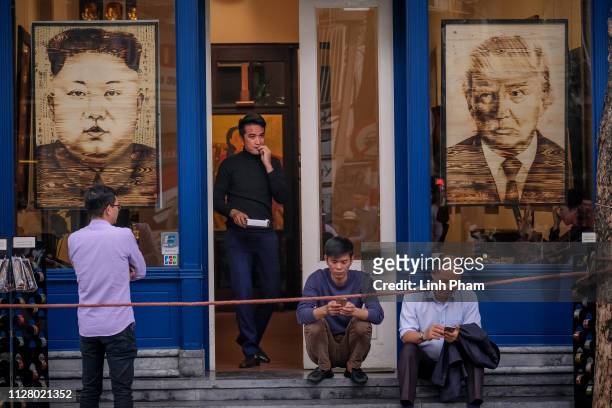 Paintings with the faces of North Korean leader Kim Jong Un and U.S. President Donald Trump are on display at local stores during the summit on...