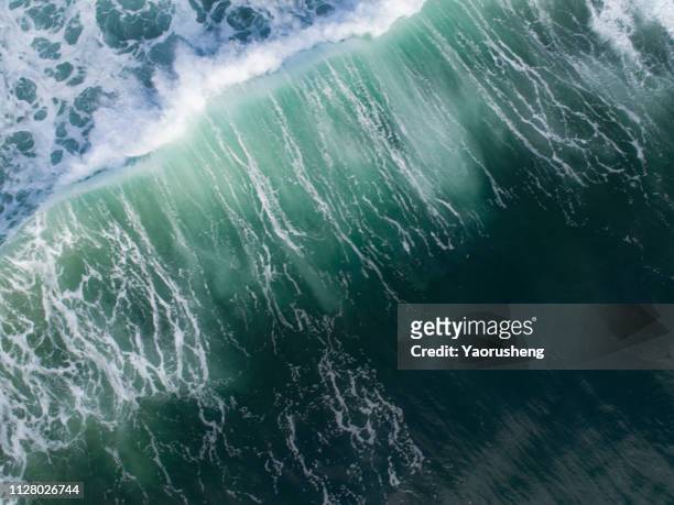 aerial view of big wave on the sea - gezeiten stock-fotos und bilder