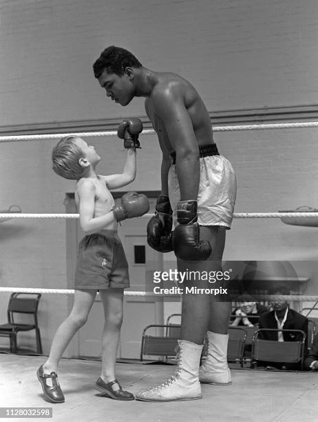 American boxer Cassius Clay with 6 year old Patrick Power in the ring during his training for the Heavyweight non-title fight against Henry Cooper at...