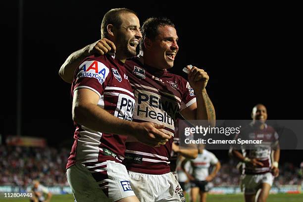 Michael Robertson of the Sea Eagles celebrates scoring a try with team mate Anthony Watmough during the round seven NRL match between the Manly...