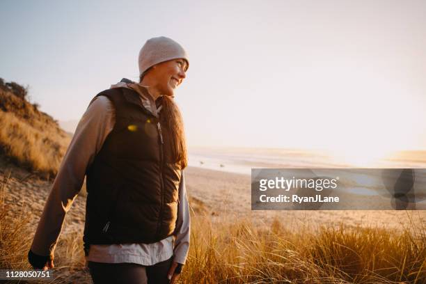 mature adult woman hiking at oregon coast - carefree beach stock pictures, royalty-free photos & images