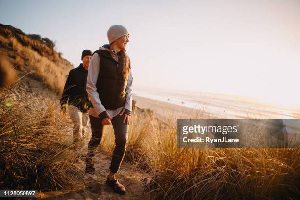 loving mature couple hiking at oregon coast - jacket stock pictures, royalty-free photos & images