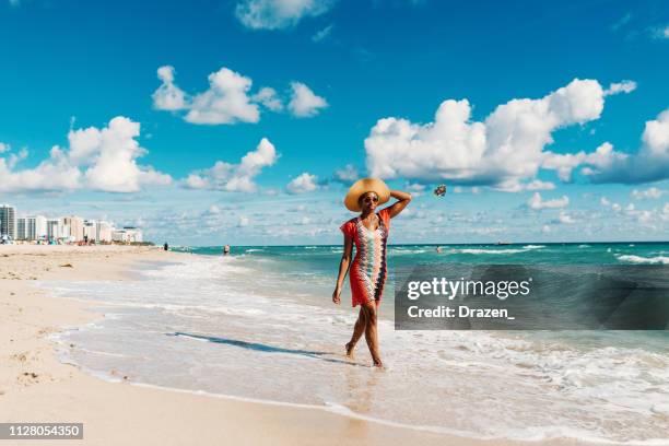 afro-caribbean woman enjoys summer at the beach in usa - miami florida stock pictures, royalty-free photos & images