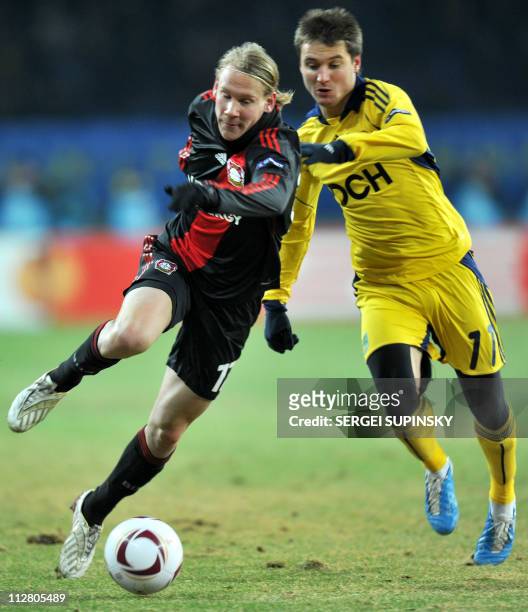 Metalist Kharkiv's Denys Oliynyk vies with Bayer Leverkusen's Domagoj Vida during their UEFA Europa League round of 32 first leg football match in...