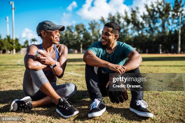 latin couple dating and flirting after game of baseball in usa - puerto rican woman stock pictures, royalty-free photos & images