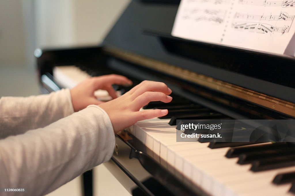 Close up hands playing piano.