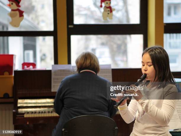 girl playing recorder at the concert. - christmas concert stock pictures, royalty-free photos & images