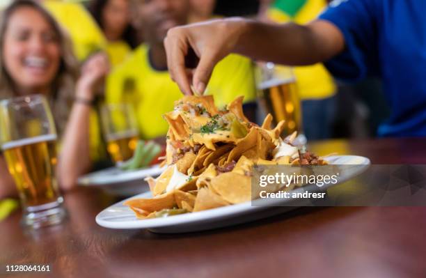 close up on nachos at a sports bar - mexican food and drink stock pictures, royalty-free photos & images