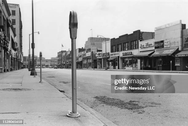 Looking west from Main St. On Futon St. In Hempstead, New York on July 4, 1966. The street is empty and many storefronts are visible.