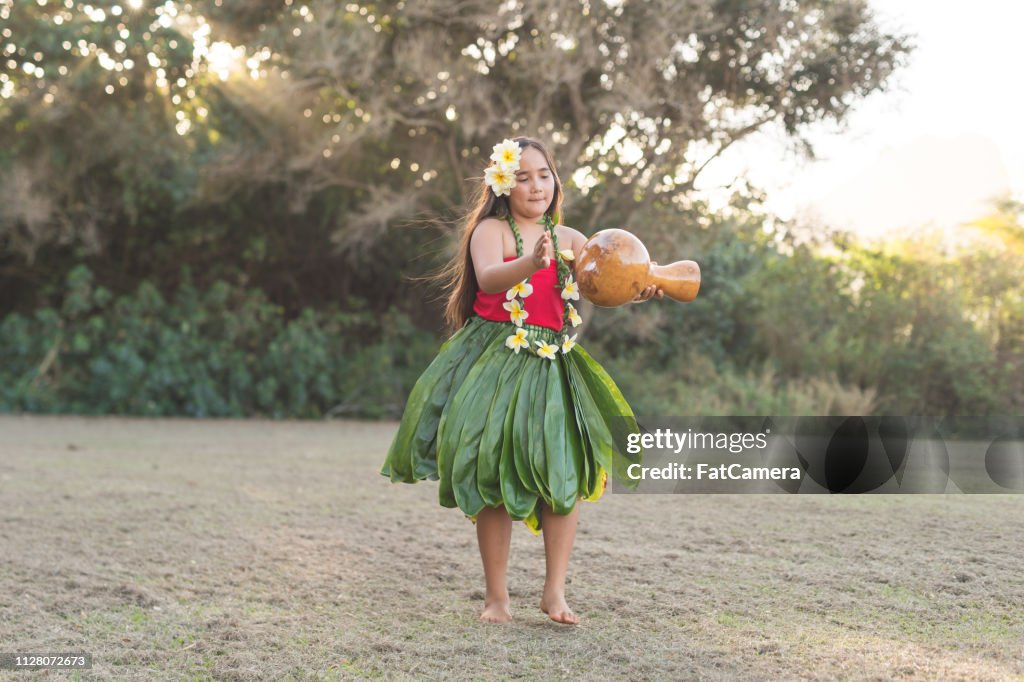 Young girl practicing hula outside