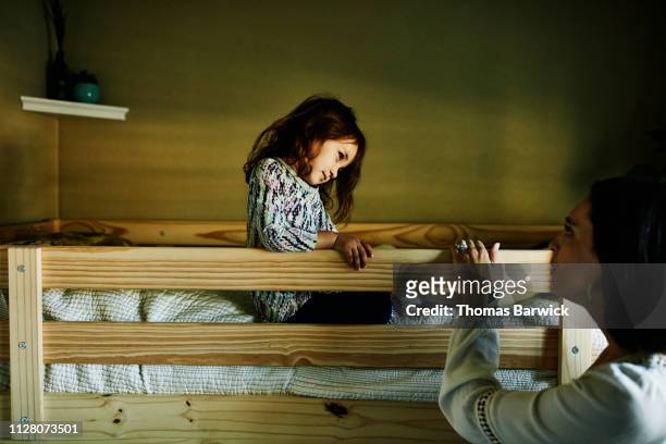 mother trying to get young daughter to take nap in bedroom - bunk beds for 3 stock-fotos und bilder