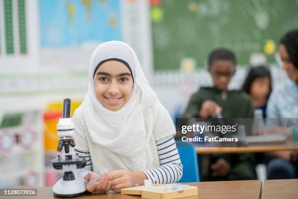 girl with microscope - arab student kids stock pictures, royalty-free photos & images