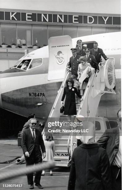 Former First Lady Jacqueline Kennedy smiles as she descends the airstair leading out of a Pan American Airways airplane at Kennedy Airport in...