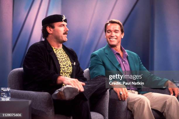 American actor and wrestler Jesse Ventura Austrian-American actor and bodybuilder Arnold Schwarzenegger promote their film 'Predator' on an episode...