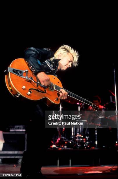 American Rockabilly and Rock musician Brian Setzer, of the group Stray Cats, plays guitar as he performs onstage at the Marcus Amphitheater,...