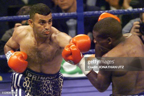 Prince Naseem Hamed of England punches contender Vuyani Bungu of South Africa during their WBO Featherweight title bout 11 March 2000 at the Olympia...