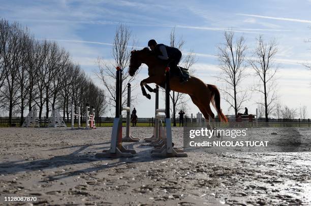 Person rides a horse before considering purchasing it on February 8, 2019 at Chateau Bacon in Saint-Vincent-de-Paul near Bordeaux, southwestern...