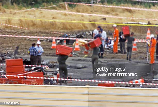 Des experts et des enquêteurs examinent le 31 juillet 2000 à Gonesse le site, où un Concorde d'Air France s'est écrasé le 25 juillet 2000, faisant...